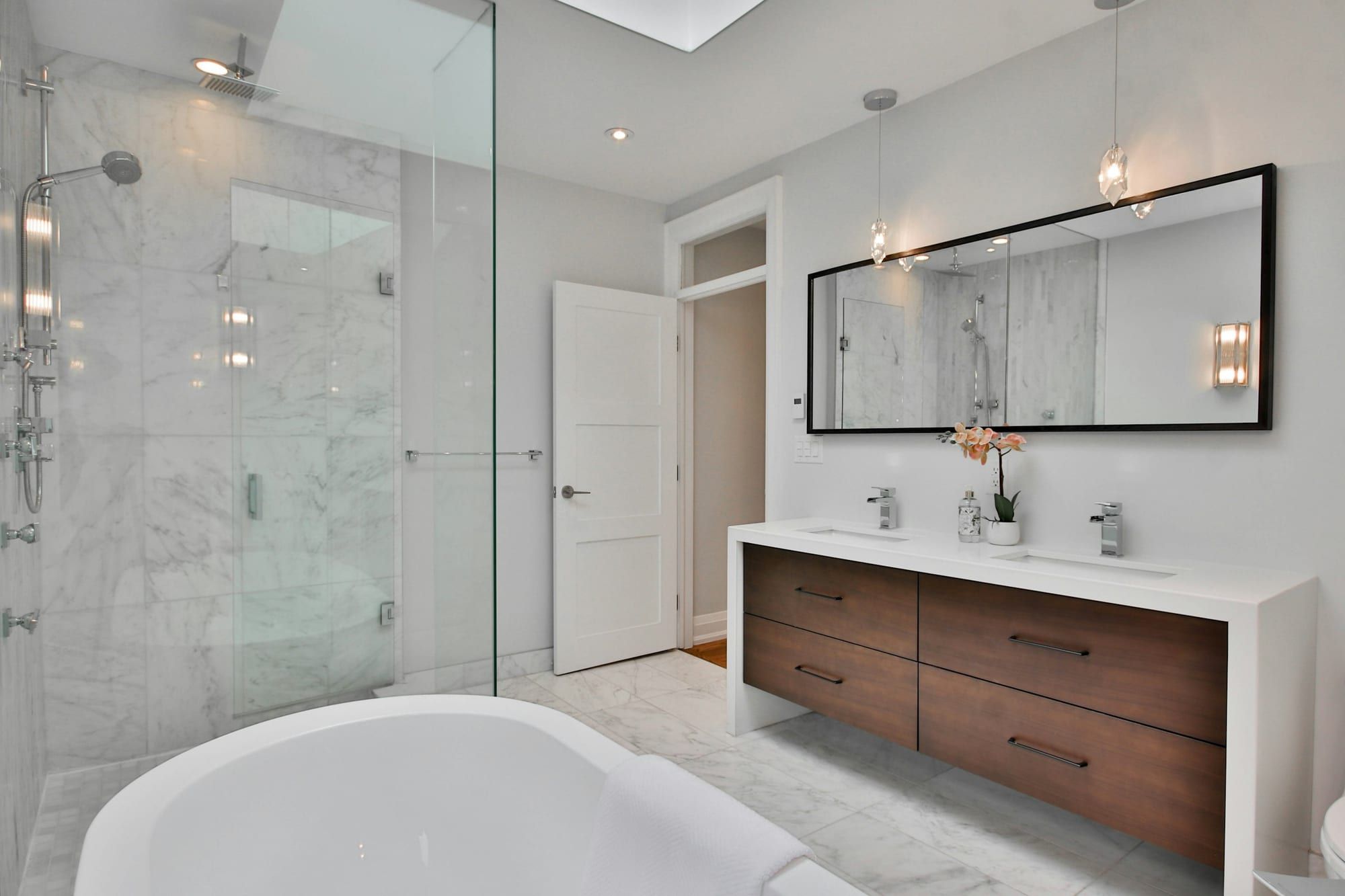 Salle de bain rénovée avec douche vitrée et double vasque
